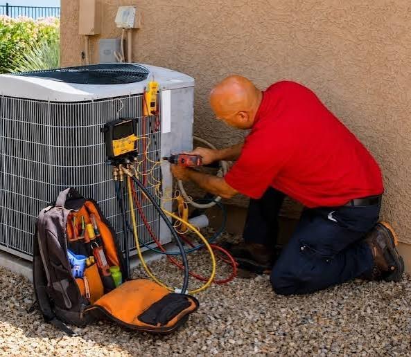 Technician servicing an outdoor residential air conditioner